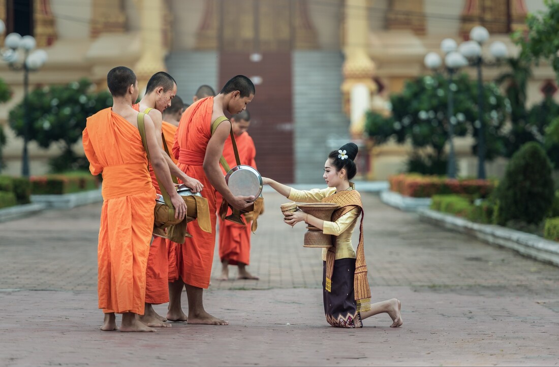 Woman giving to monks