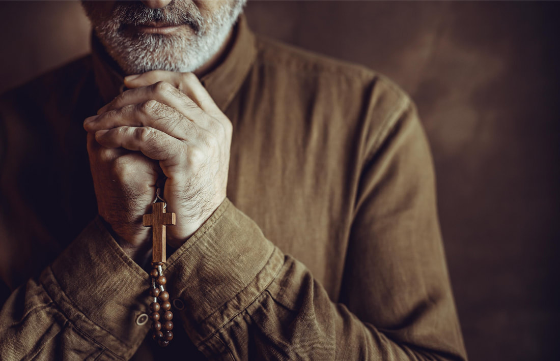 Priest with rosary